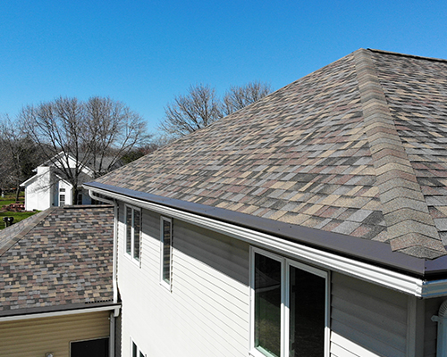A photo of the roof on a home that features asphalt shingles