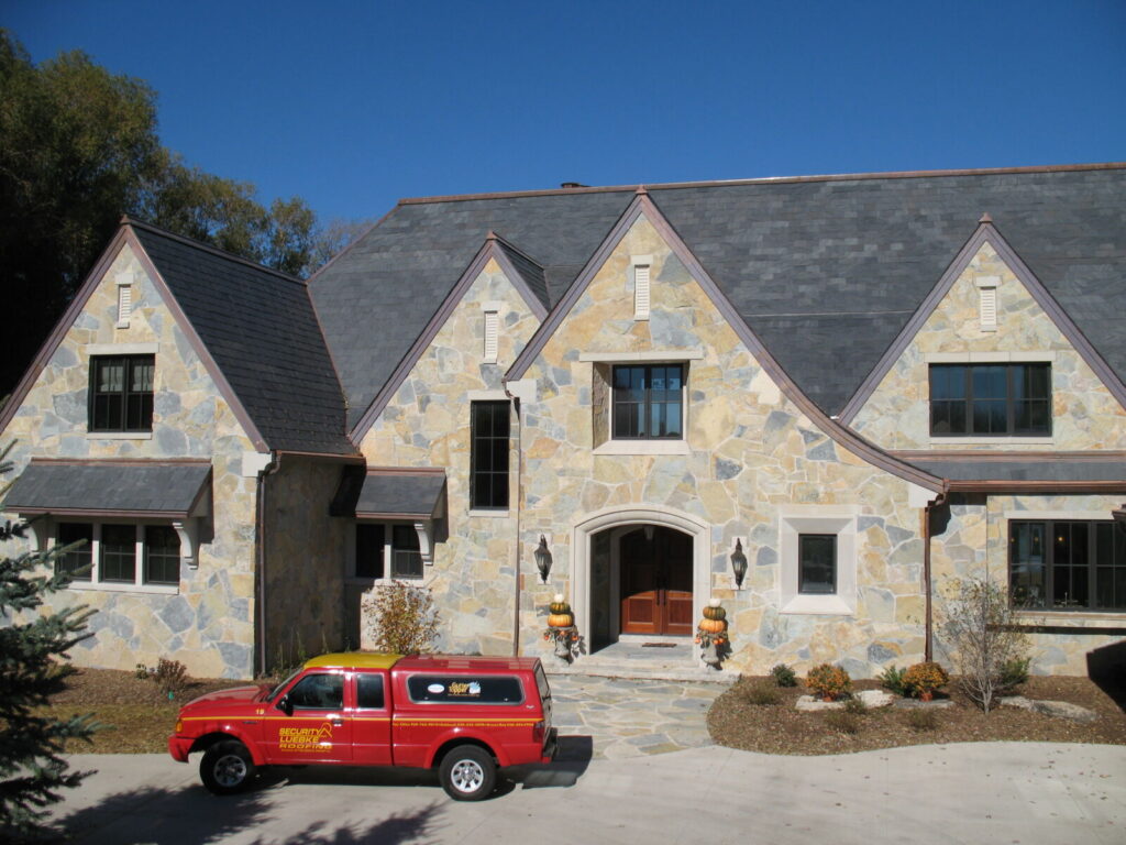 roofing contractor at job site with security-luebke truck